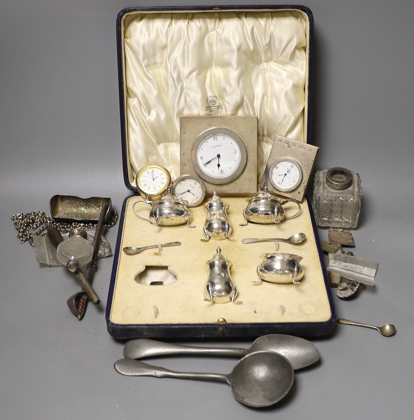 Sundry small silver including a cased part condiment set, three modern silver mounted desk timepieces and a Georgian vinaigrette and thirteen other items including pewter flatware etc.